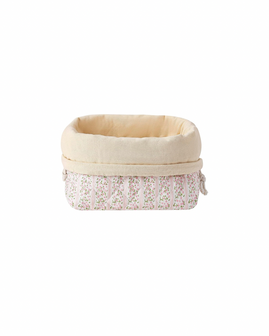 Small fabric basket with floral pattern on a white background