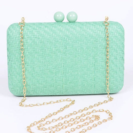 Mint green clutch bag with gold chain on a white background