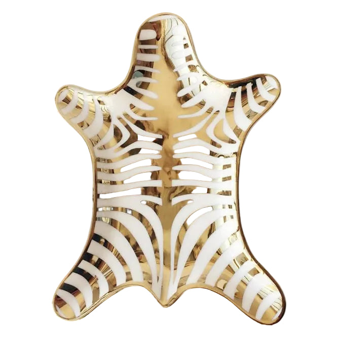 Decorative plate with gold and white zebra pattern on a white background
