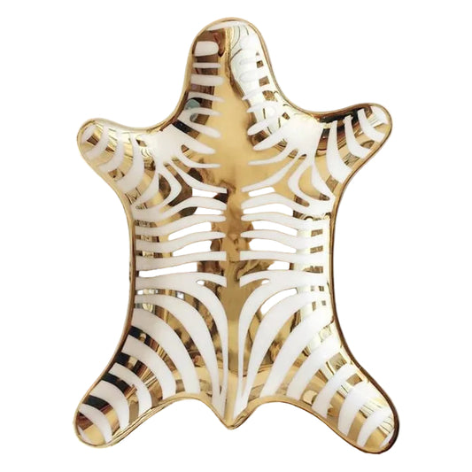Decorative plate with gold and white zebra pattern on a white background
