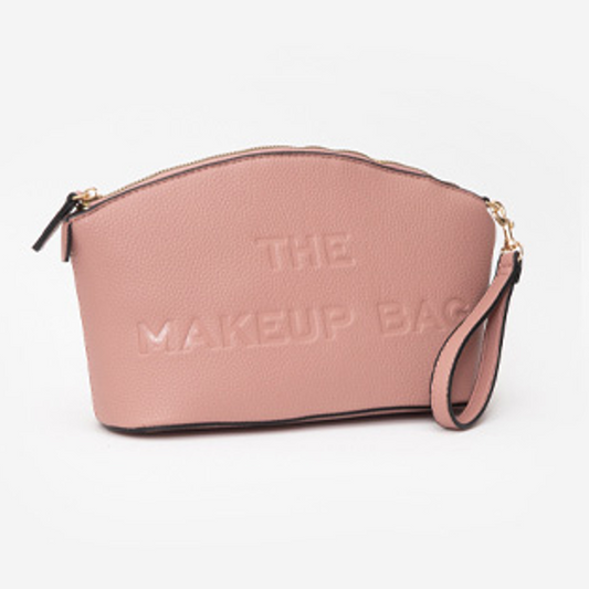 Pink makeup bag with 'THE MAKEUP BAG' text on a white background